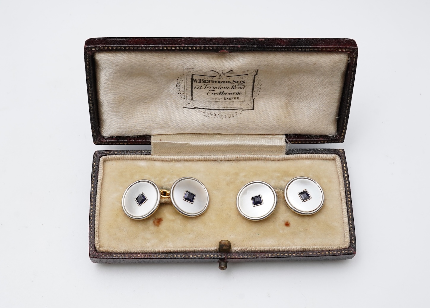 A pair of mother of pearl and sapphire cufflinks, early 20th century